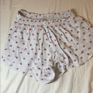 packing white and red floral shorts
